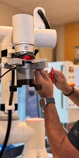 Hands fitting a gripper to a cobot